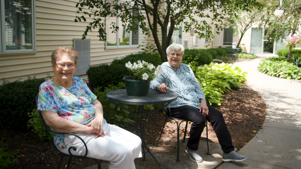 Two women sitting and smiling