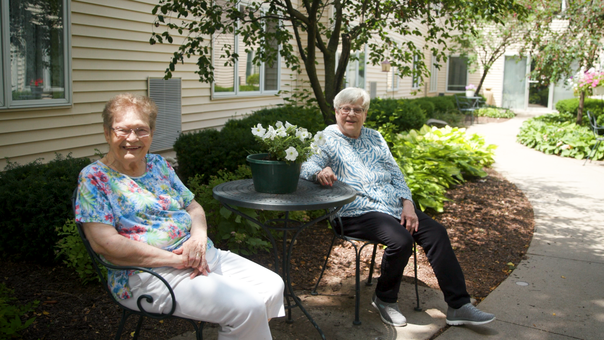 Two women sitting and smiling 